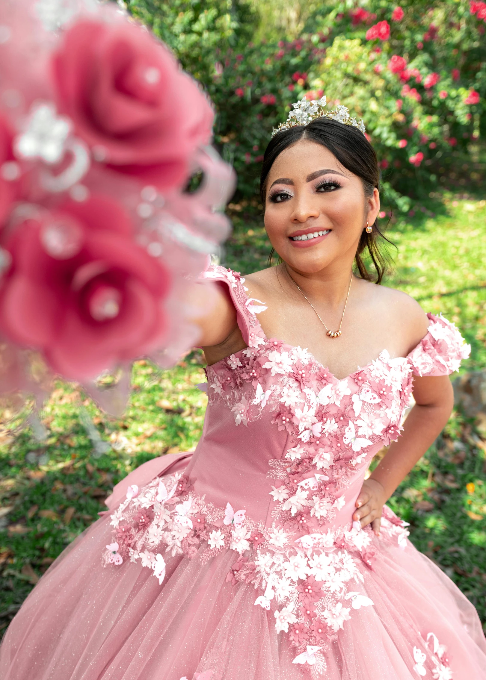 a woman in a dress holding up a flower