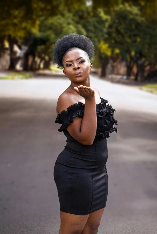 a beautiful young black woman posing in the street