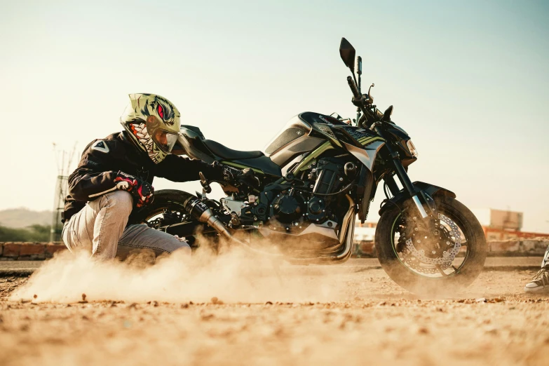 a person in a motorcycle outfit kicking up dirt