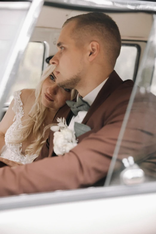 a man and woman are in a white wedding car