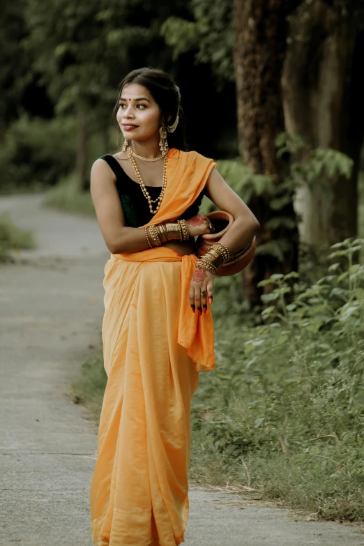 a woman dressed in a yellow sari