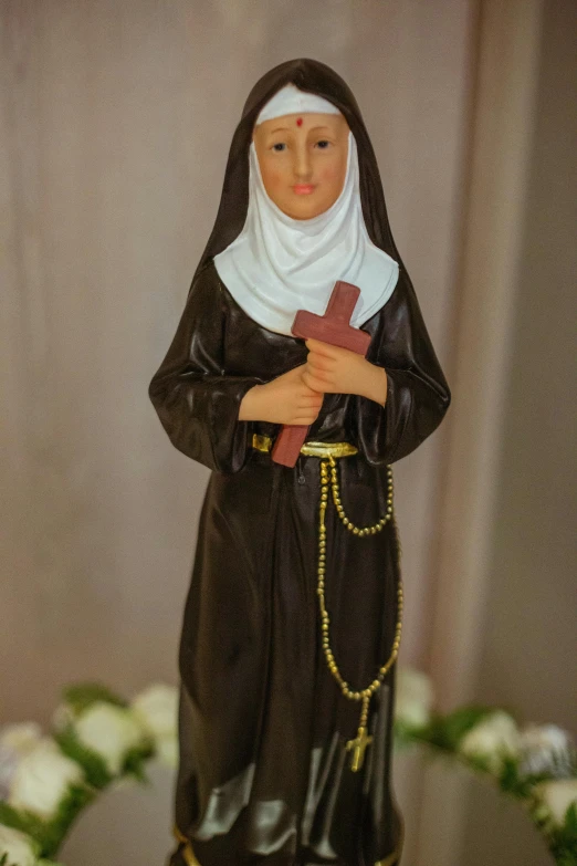 a small figurine stands with arms crossed