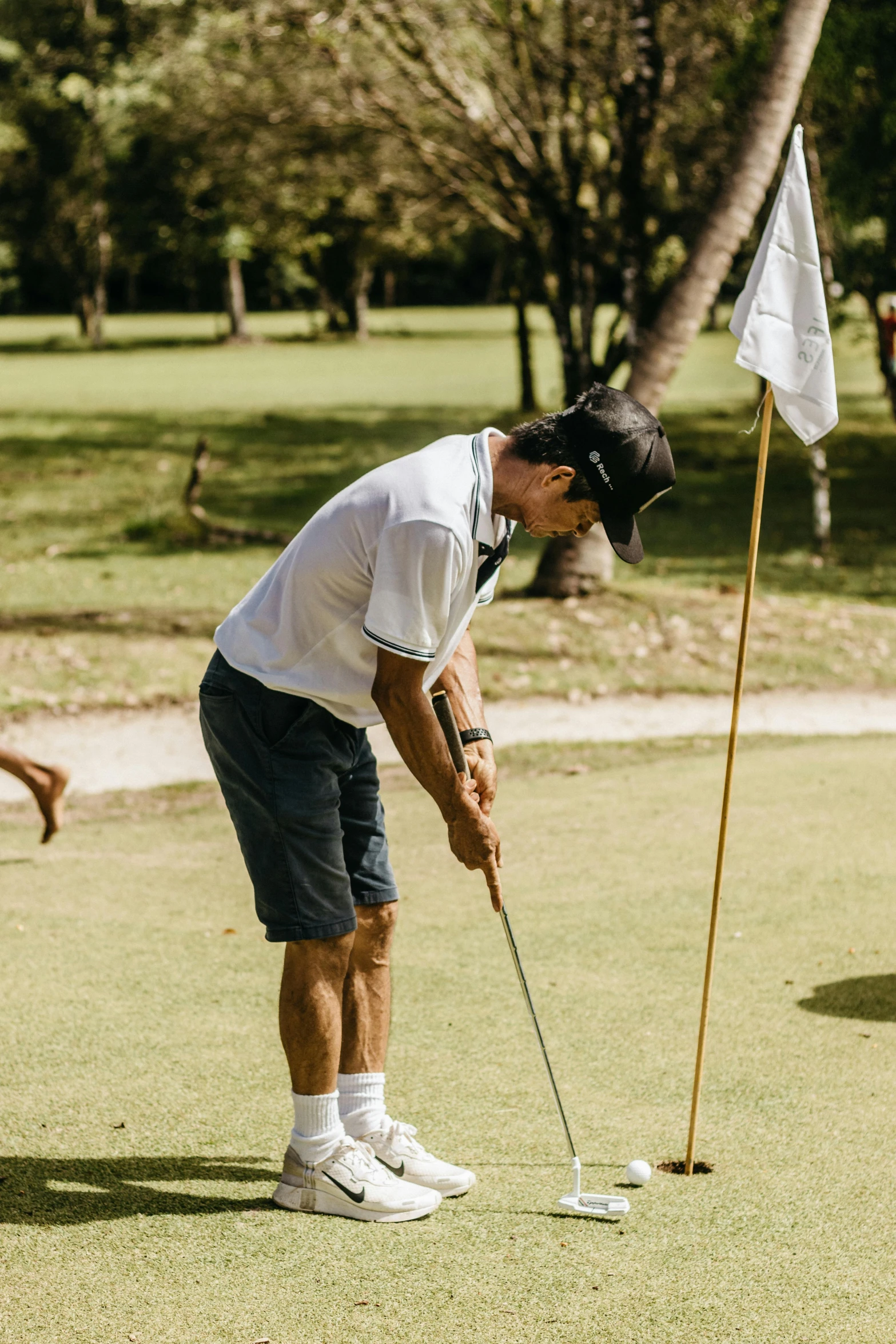 a man in a golf uniform with a golf club on a field