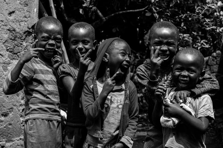 some children are standing around talking and smiling