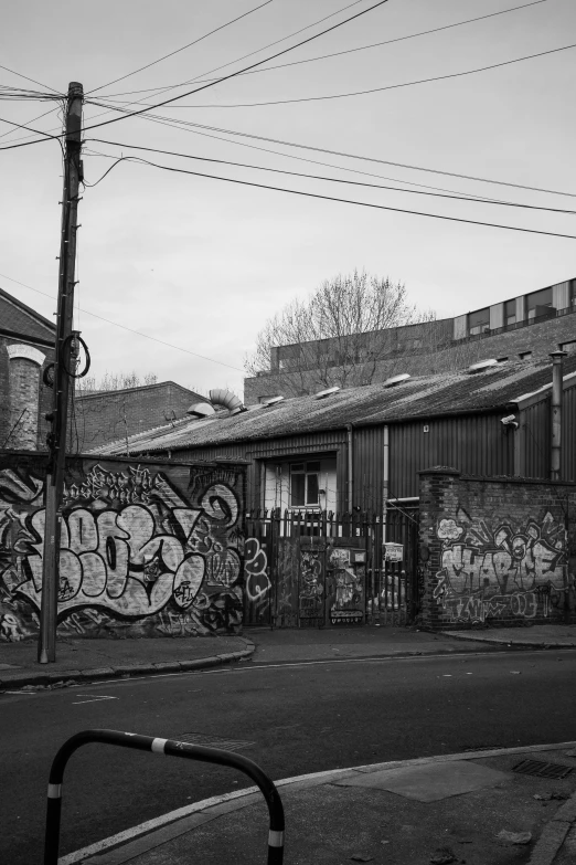 a black and white po of an alley way with lots of graffiti on the walls