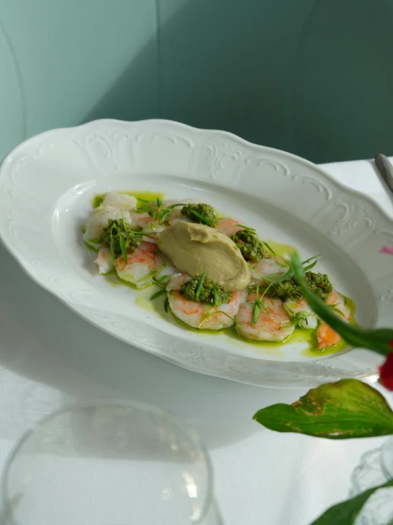 a white plate with food on it and a red rose