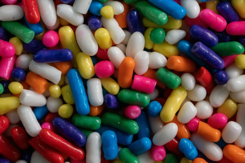 a pile of sprinkled pills sitting on top of a bed