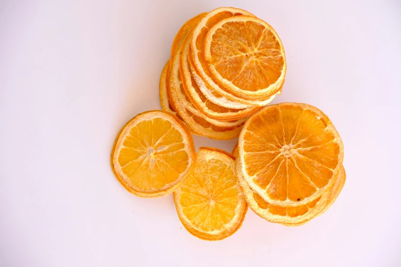 the sliced up oranges are arranged on a white table