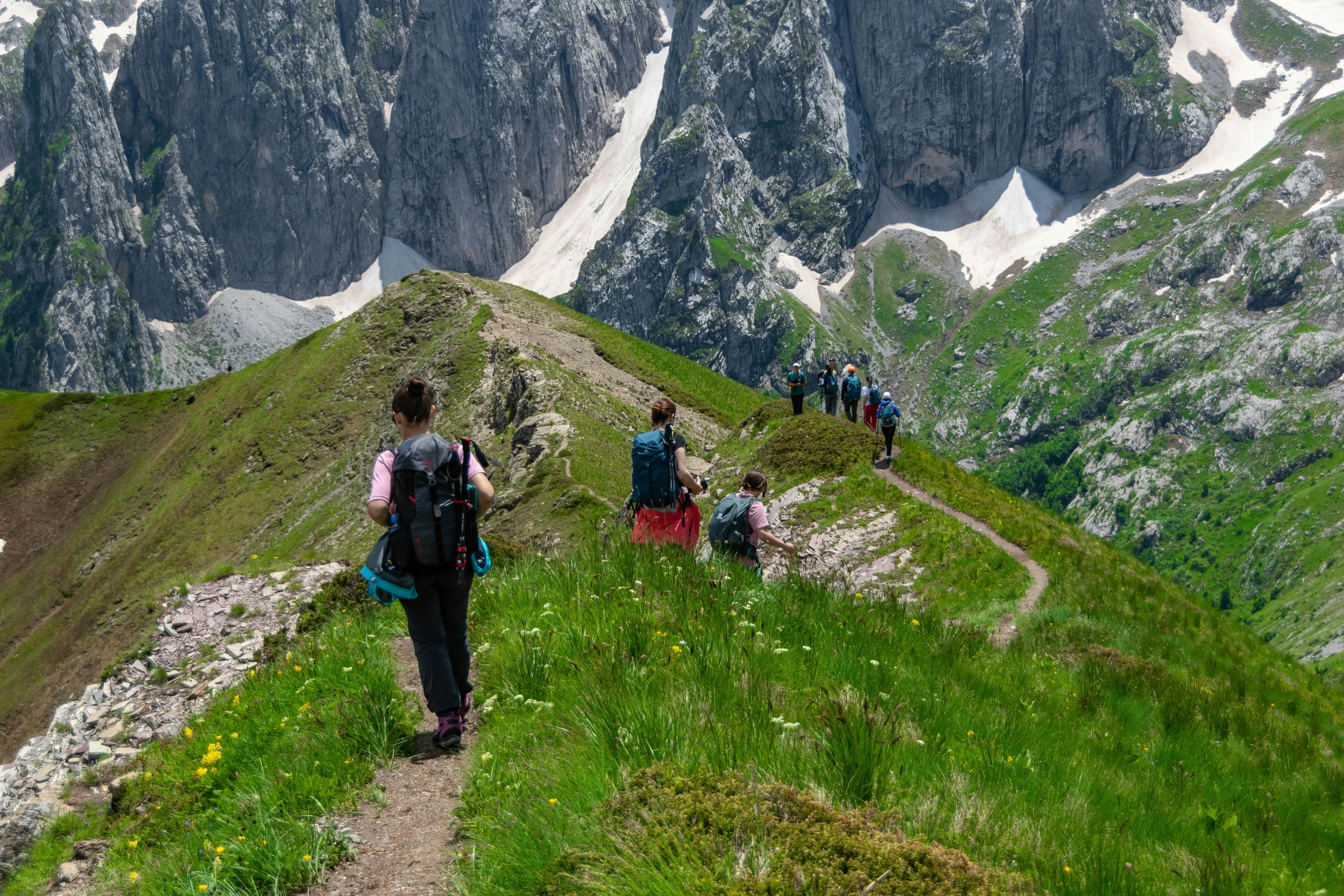 a group of people walking up the side of a mountain