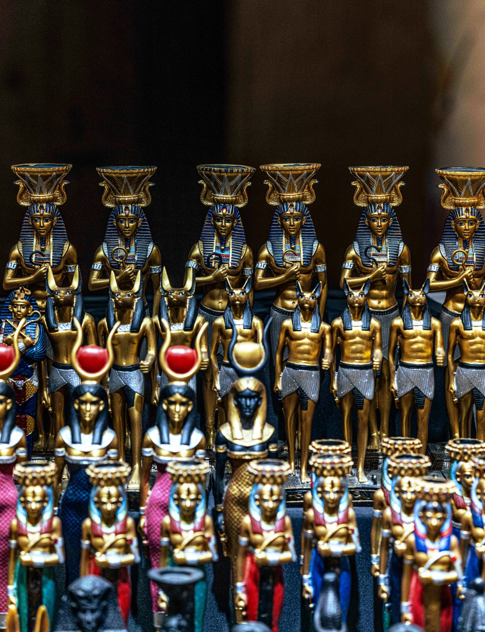 an assortment of egyptian statues in various colors