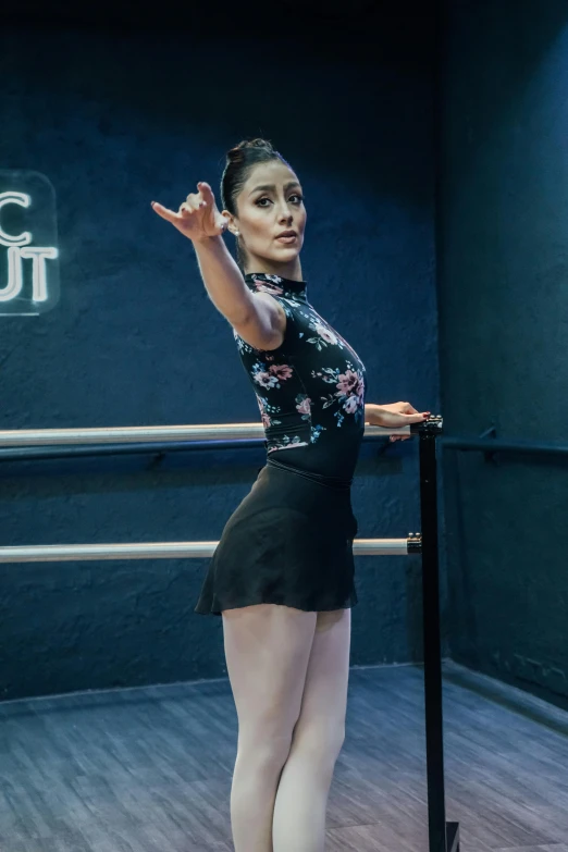 a woman in tight skirt doing tricks with a pole