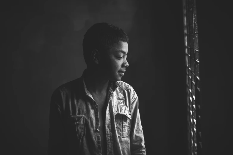 a man looking out a window while standing