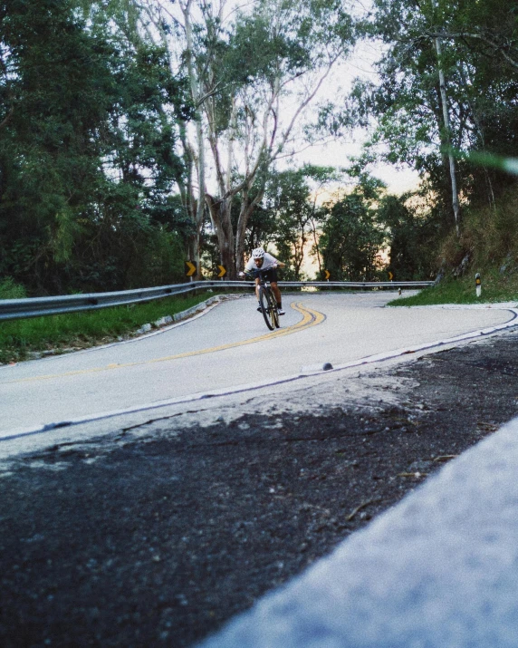 a person is riding their bike down a country road