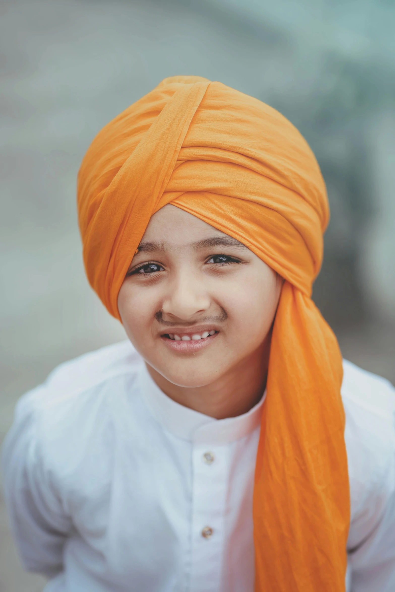 the girl is wearing a turban and smiling