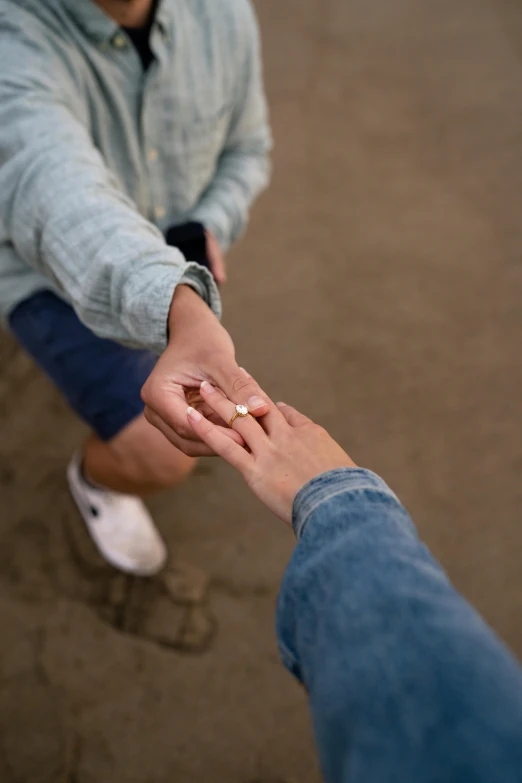 a person holding the hand of someone near the ground