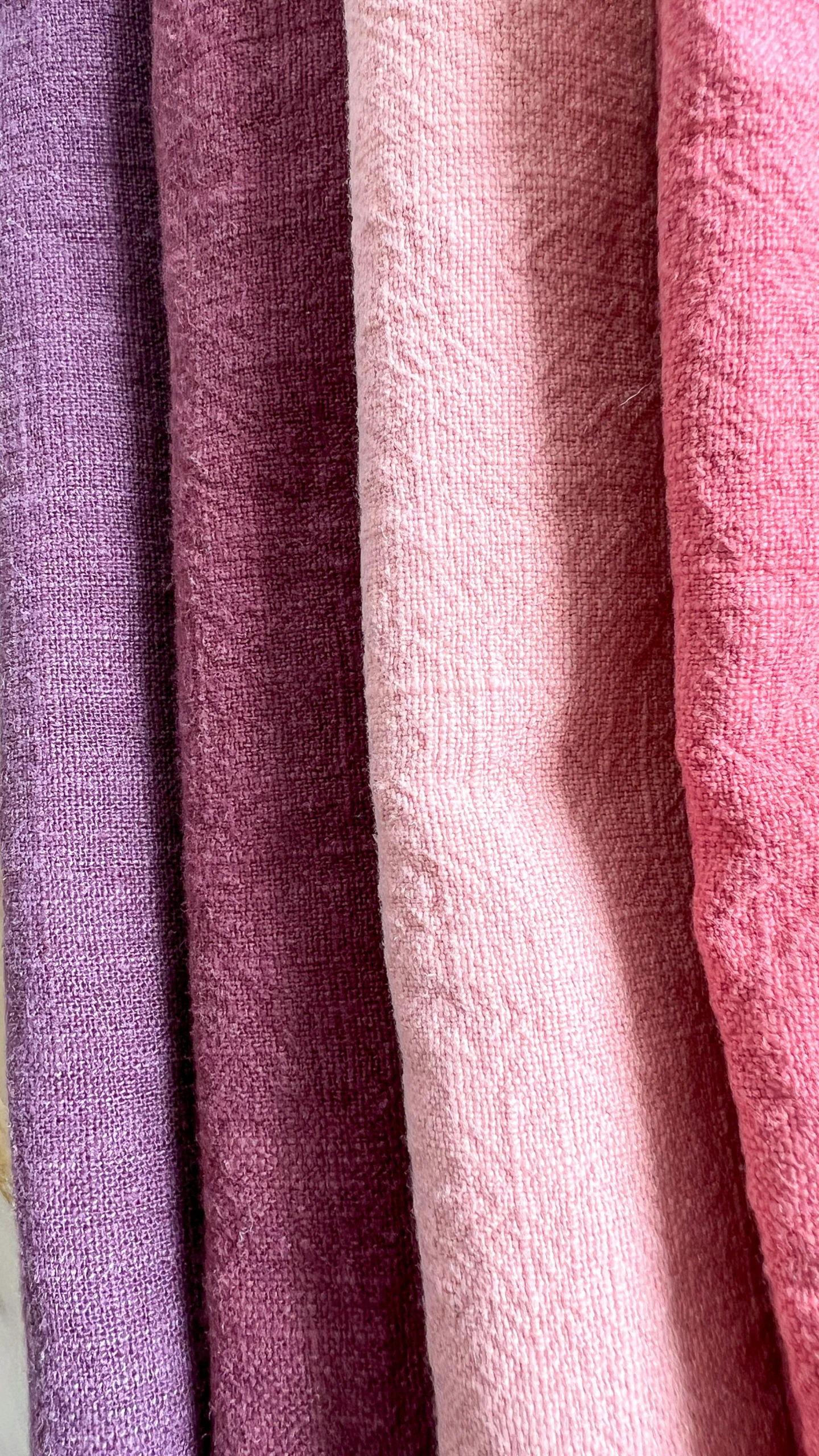 close up of four pieces of fabric, one color pink and one purple