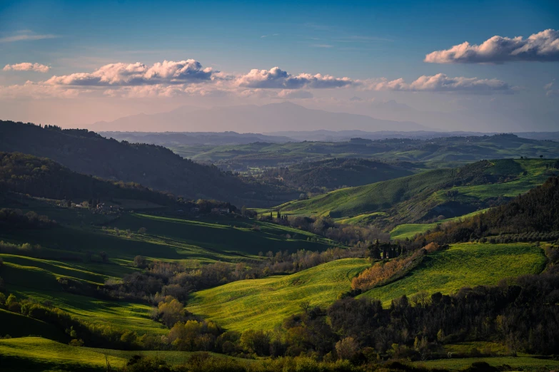 a lush valley filled with green mountains