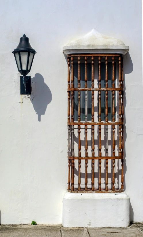 an old building with a white wall and window with bars