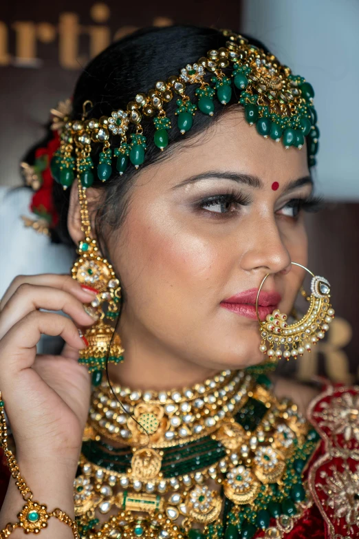 a woman wearing an elaborate head piece with lots of jewels on her neck