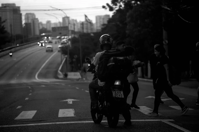 a couple people sitting on their bikes by a cross walk