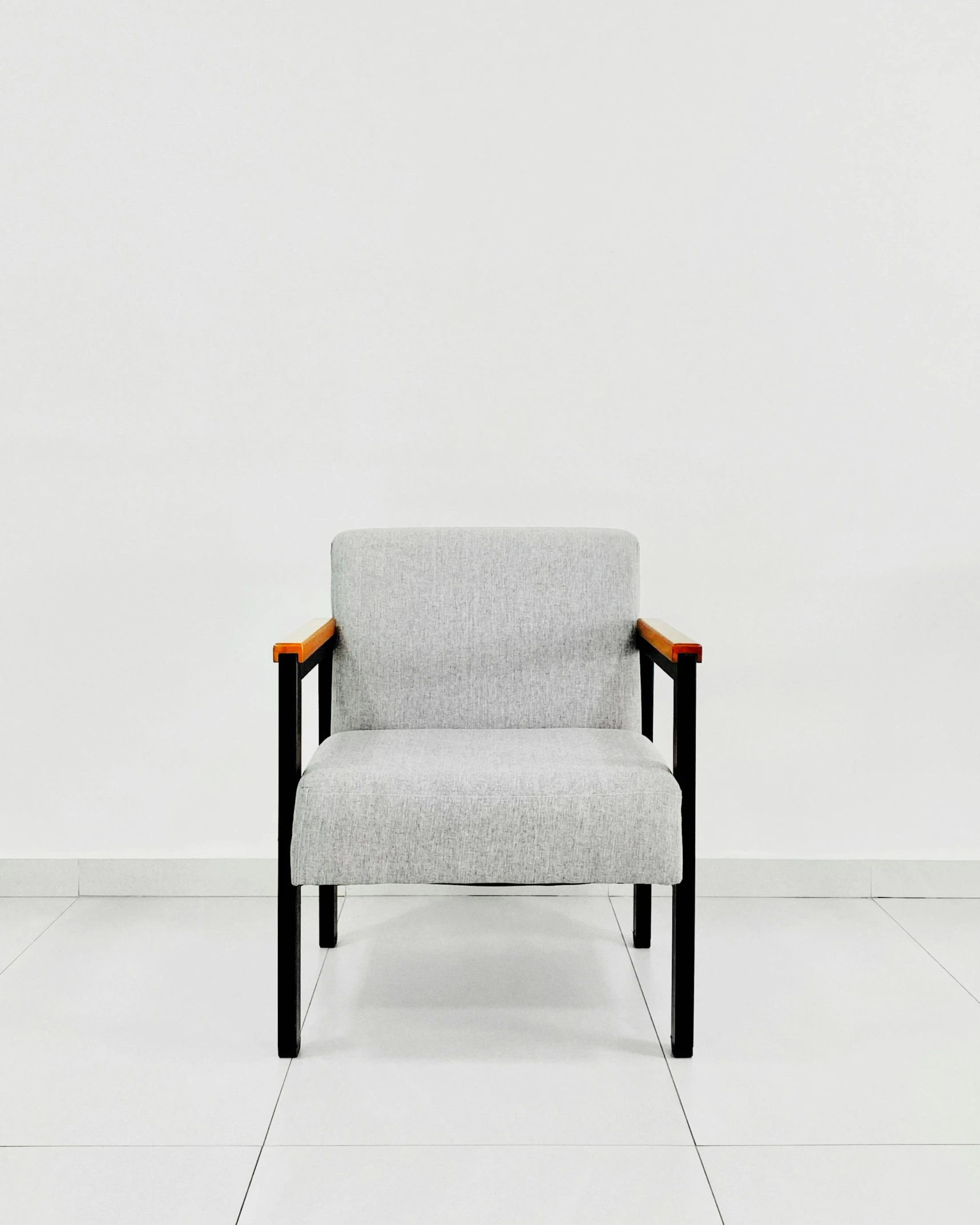 a grey chair sitting in an empty room