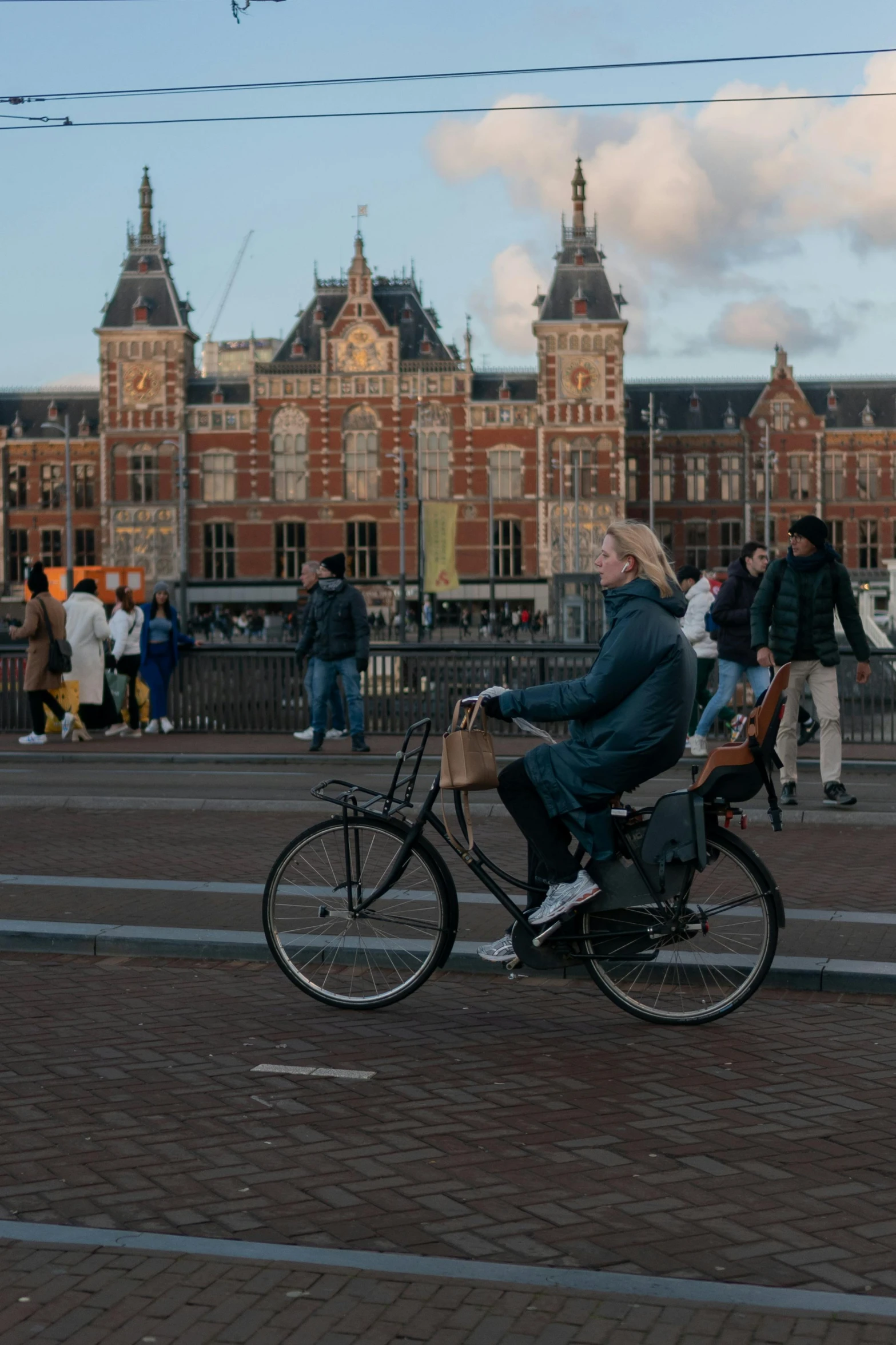 an old woman sitting on a bicycle in a courtyard