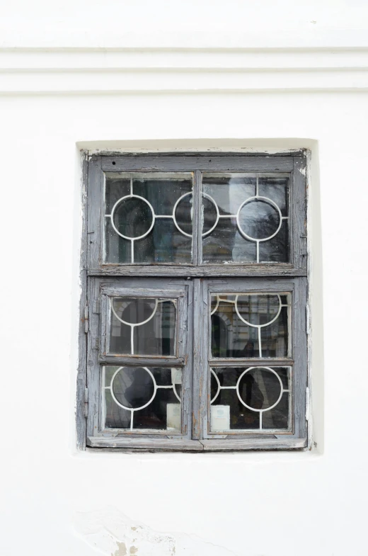window with old fashioned design on white building