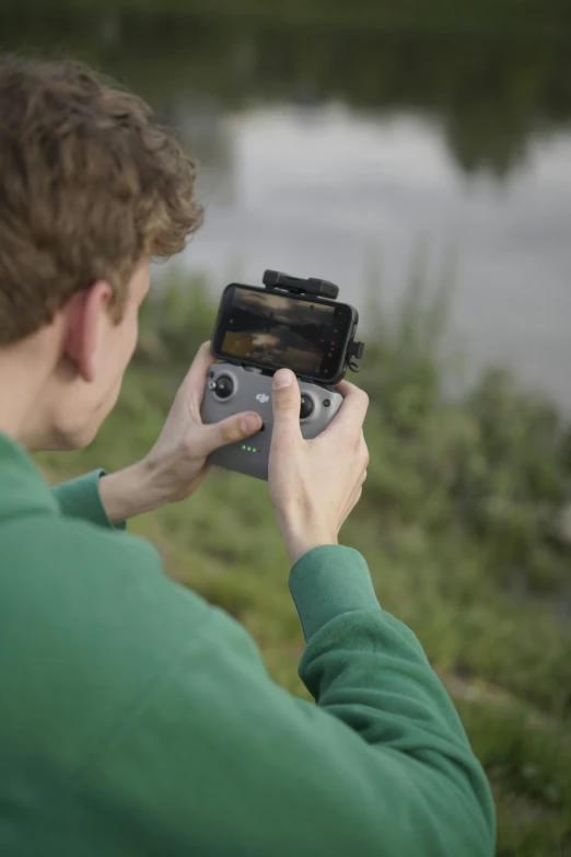 a person holds up their camera while holding it