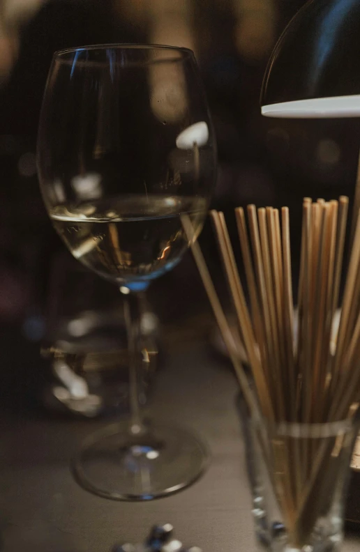 wine glasses sitting on the table in front of sticks