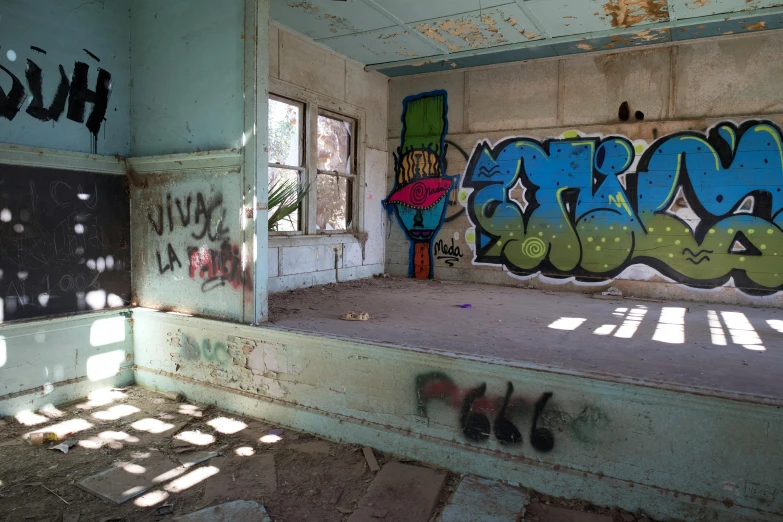 an old abandoned room has graffiti on the wall