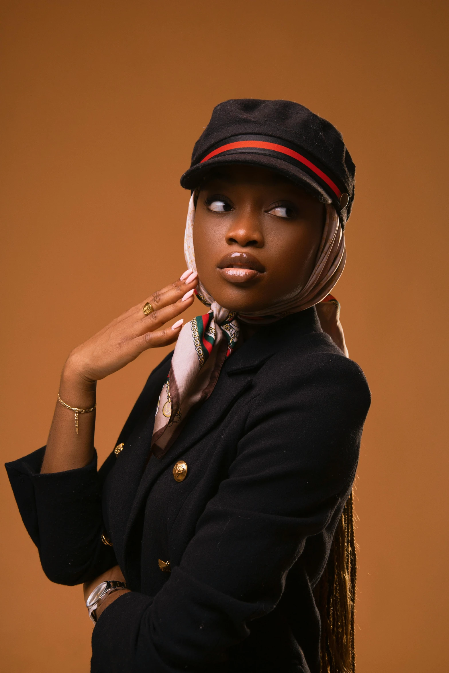 a woman wearing a hat and jacket with a scarf around her neck