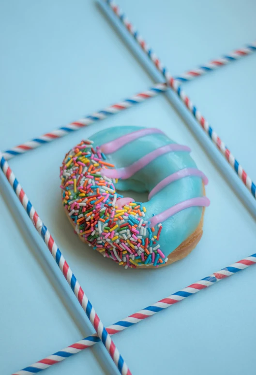 there is a doughnut with sprinkles that is on a stick