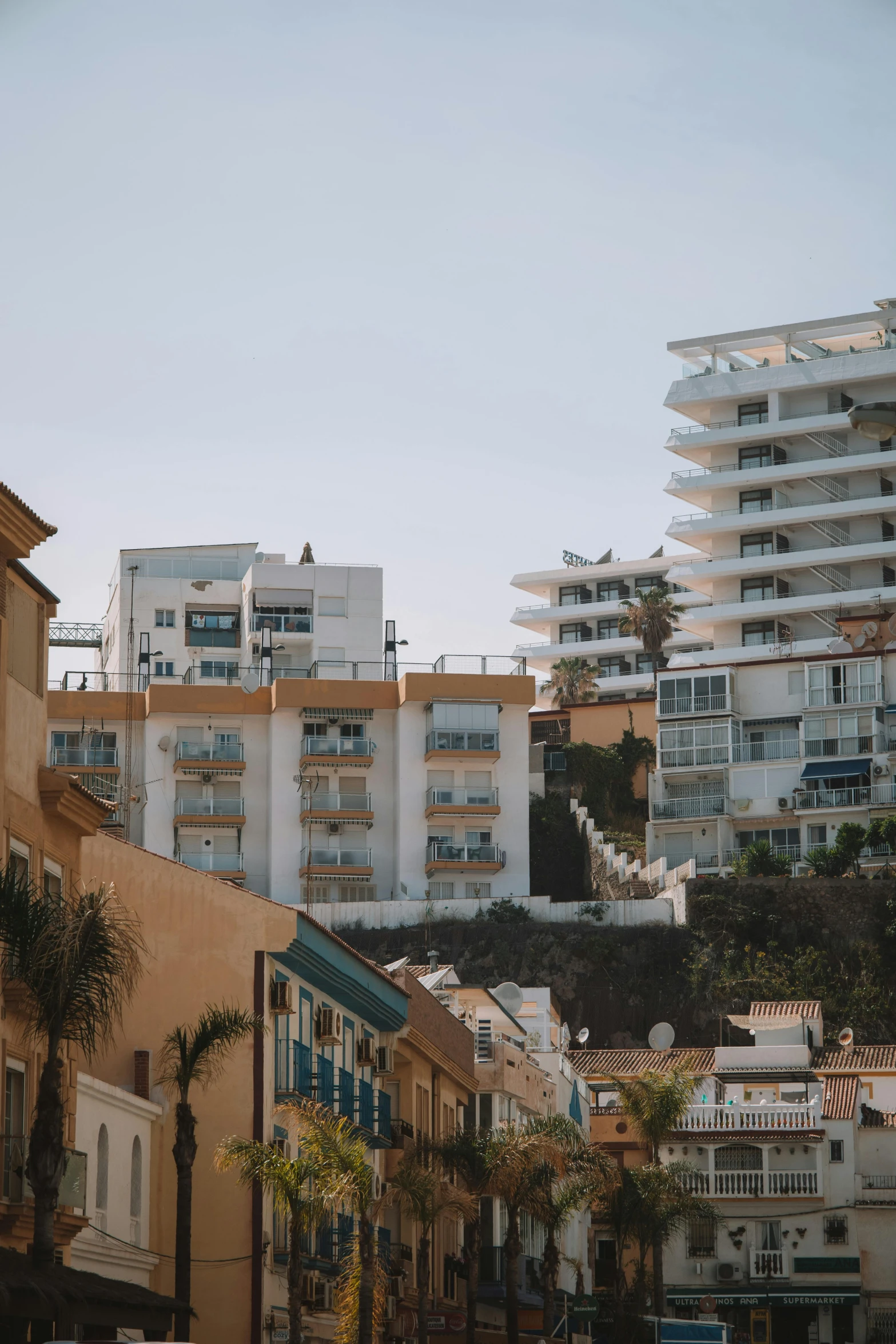 the view of buildings near each other with tall balconies