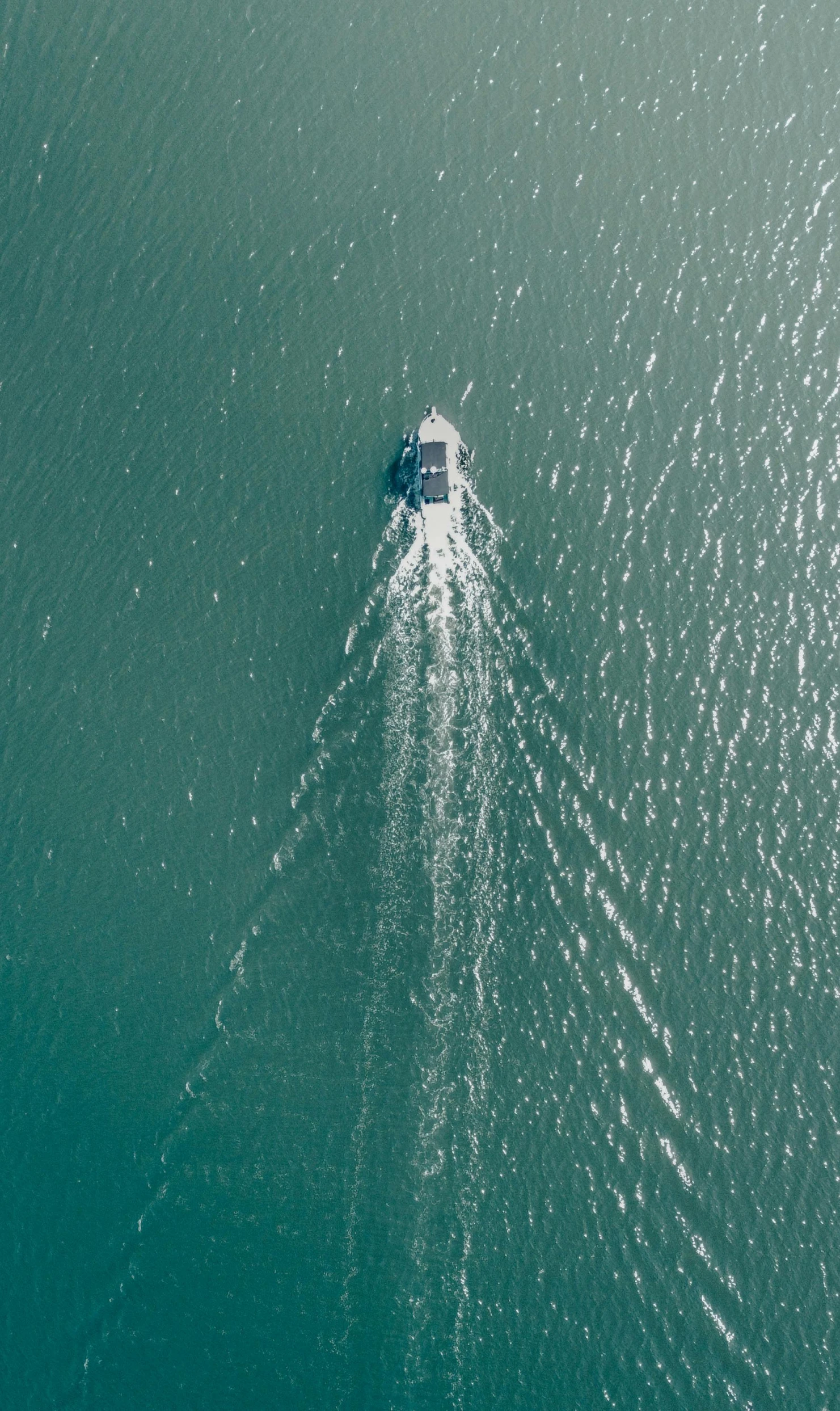 a small boat traveling across the ocean with a house on top