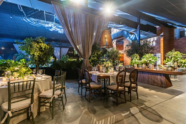 this restaurant has tables covered with flowers and greenery