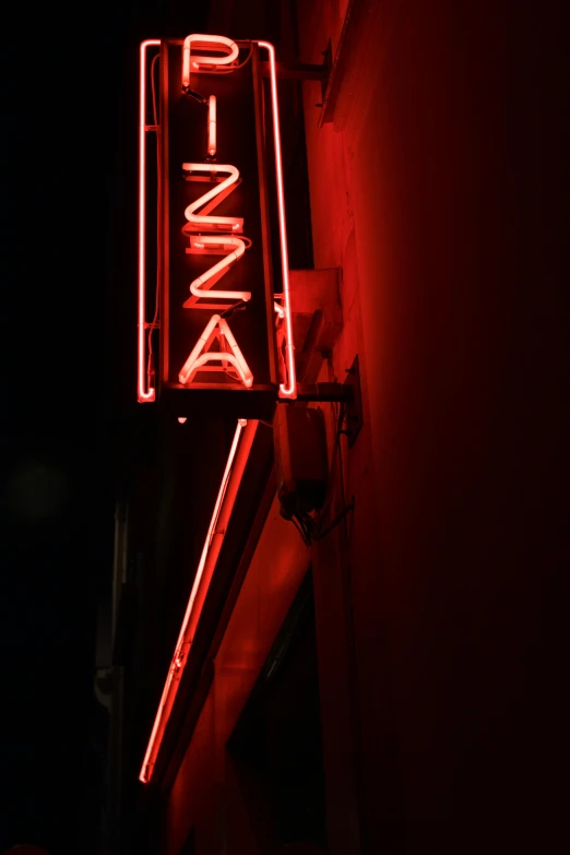 the neon sign is attached to the building