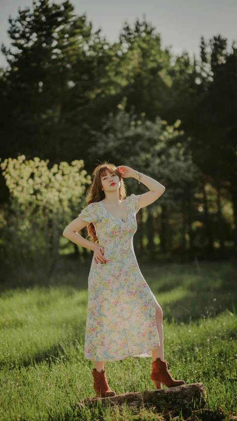 a girl standing on a log in a field