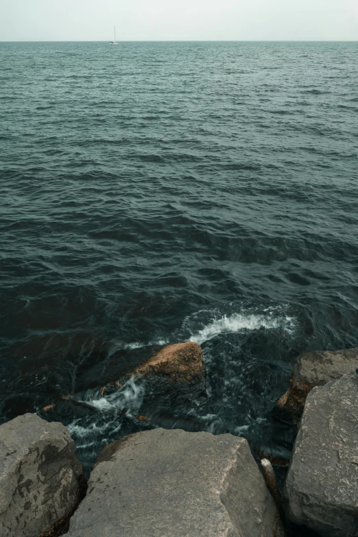 an expanse of water and rocks in front of a boat