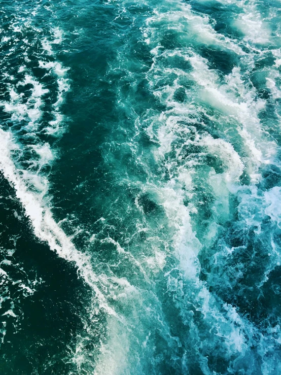 a boat traveling through the ocean surrounded by waves