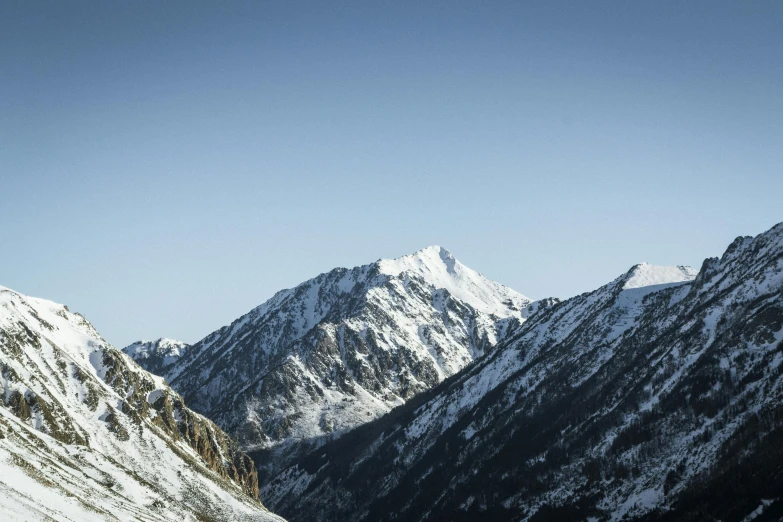 a po taken from a ski slope looking at snowy mountains