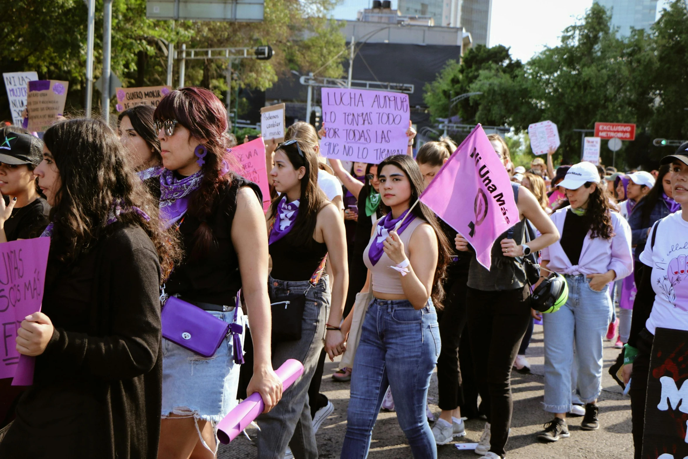 many people are holding pink signs during the event