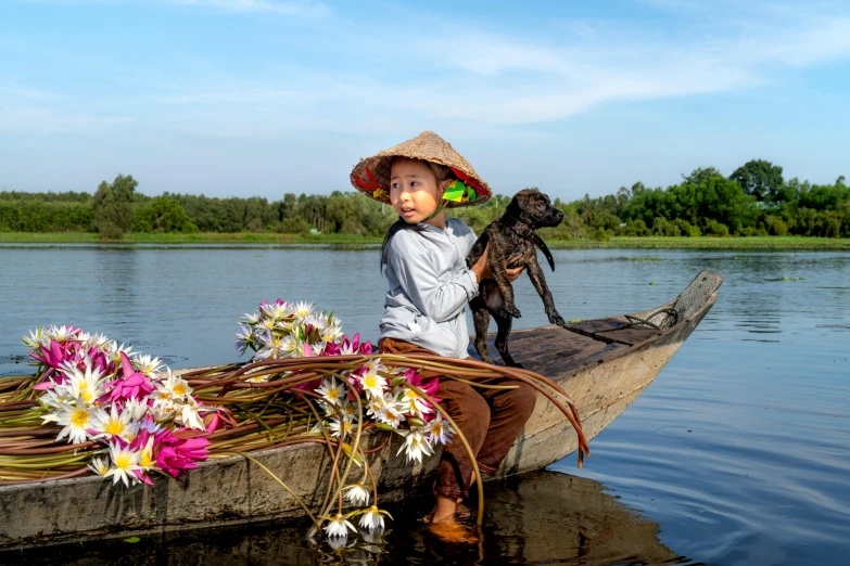 woman sitting in small boat with dog on lake