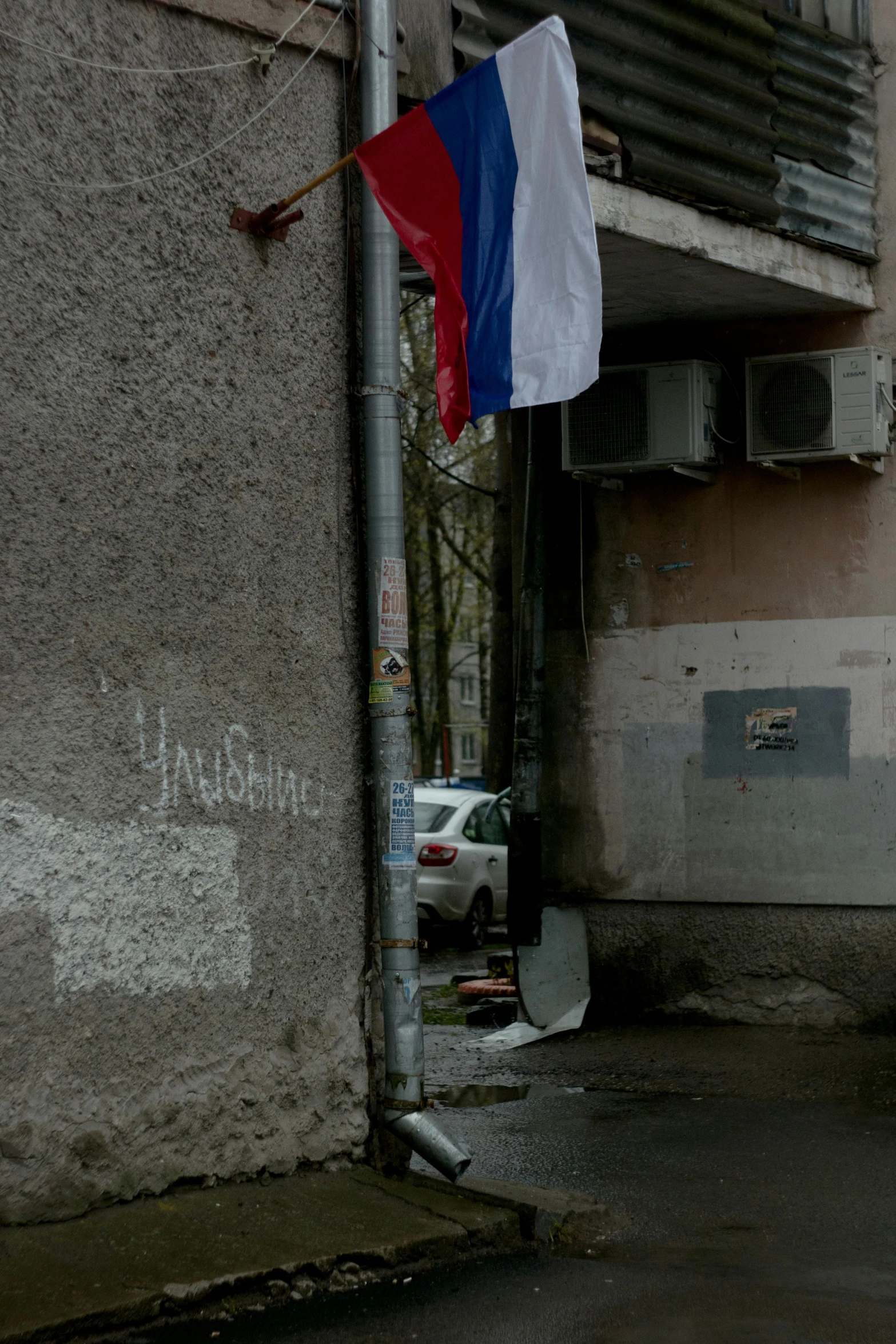 a french flag is hung on a city building