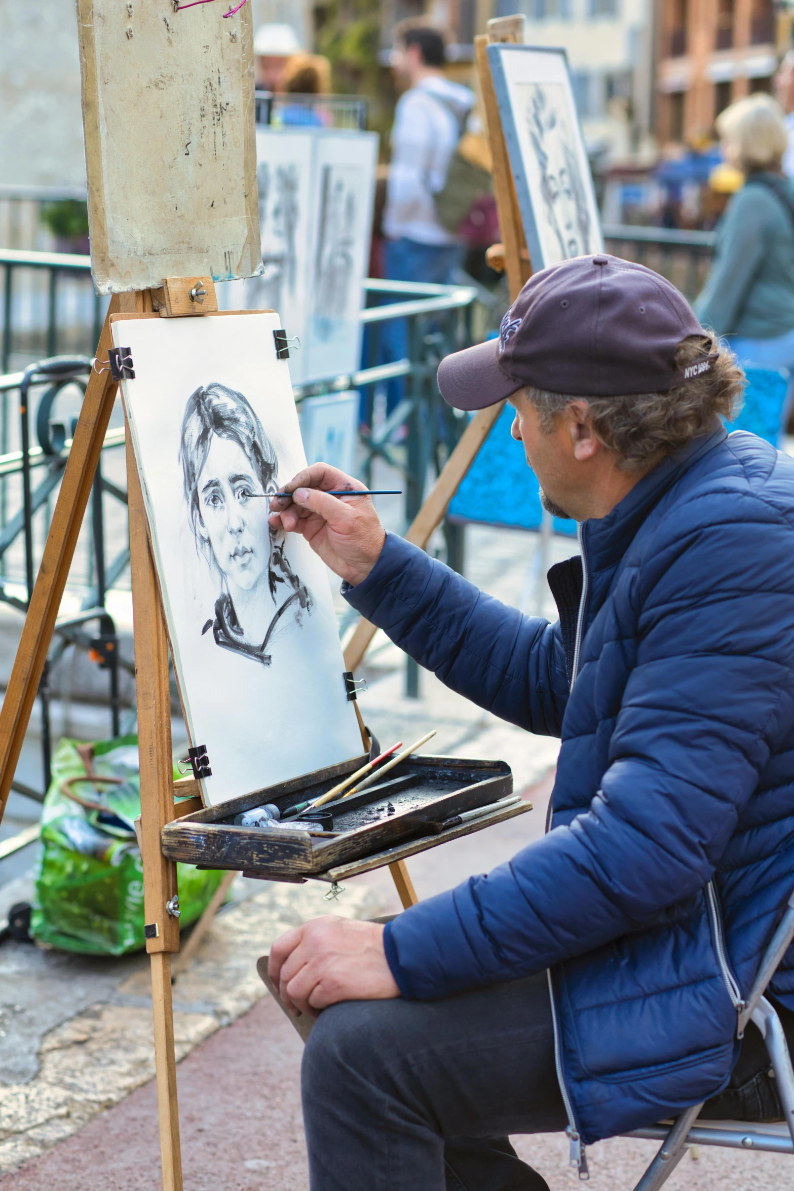 a man sitting on a chair drawing a po