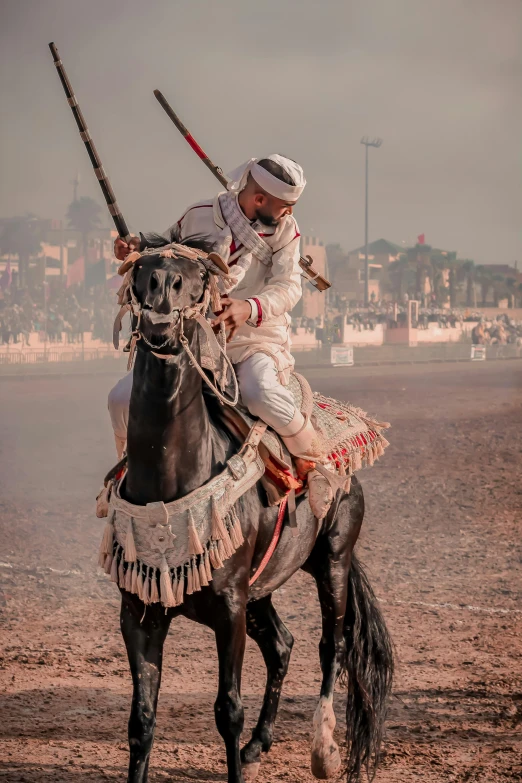 a man in white riding a horse with two swords