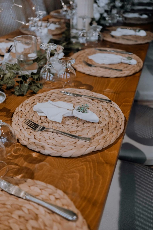 table setting with white dishes, silverware and candles
