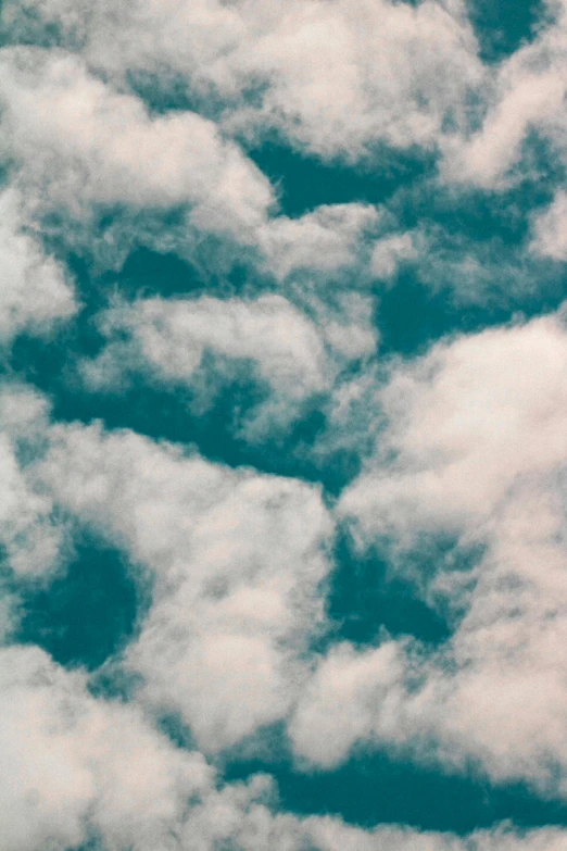 a blue sky with white fluffy clouds in the middle