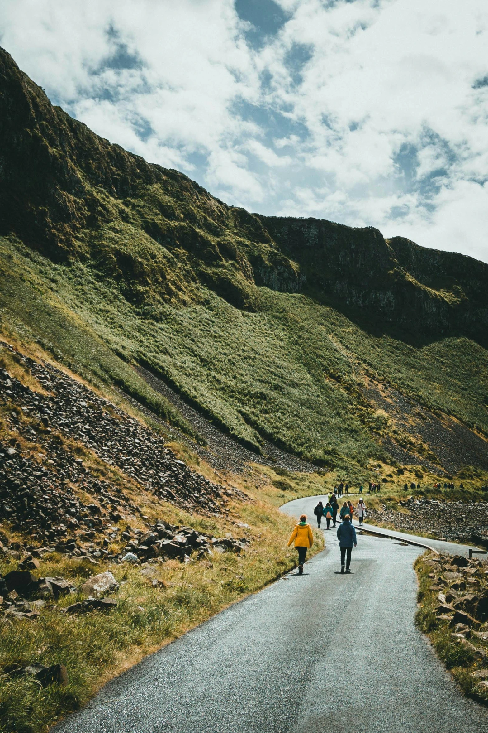 a man and two people walking up a long narrow road