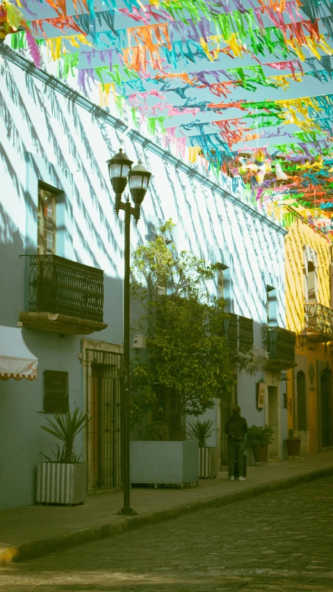 a city street is lined with colorful flags