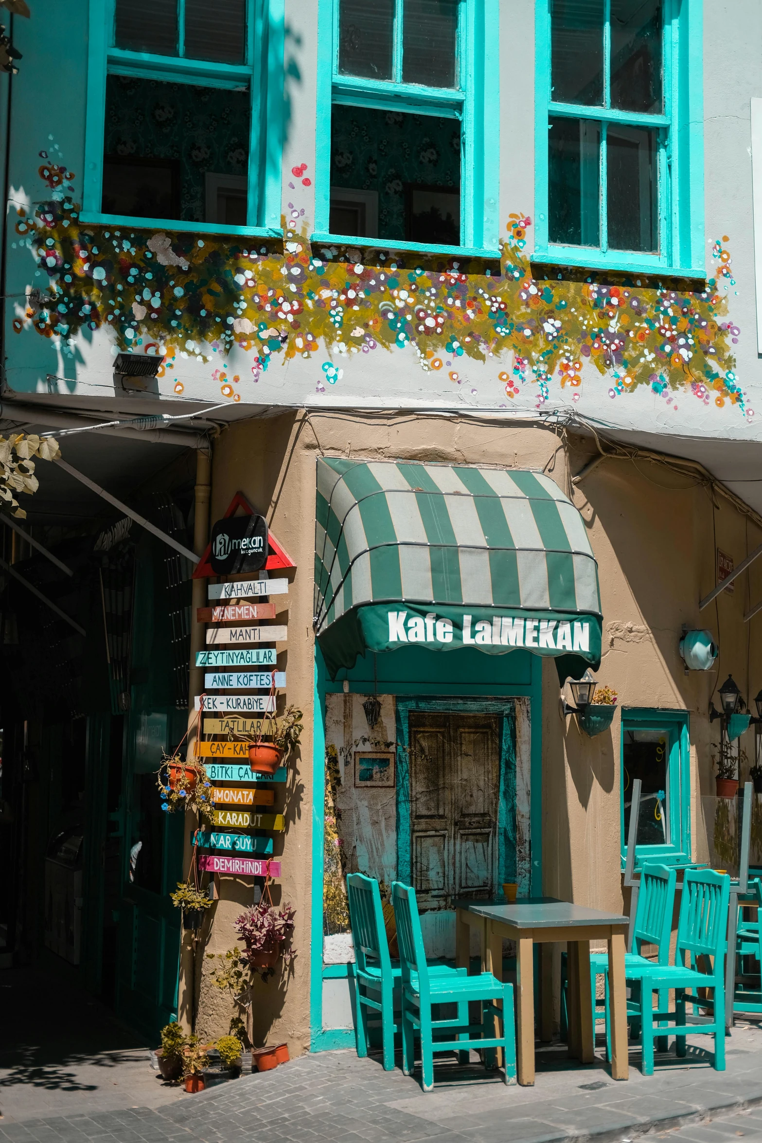 a shop with tables and chairs outside of it